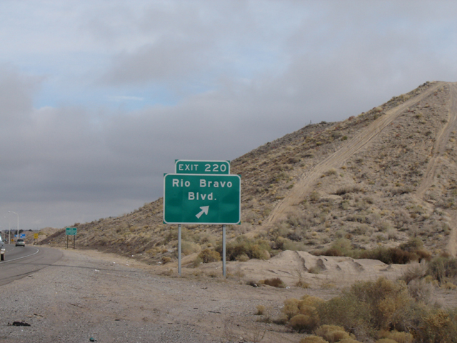 Picture of dirt road by exit sign.