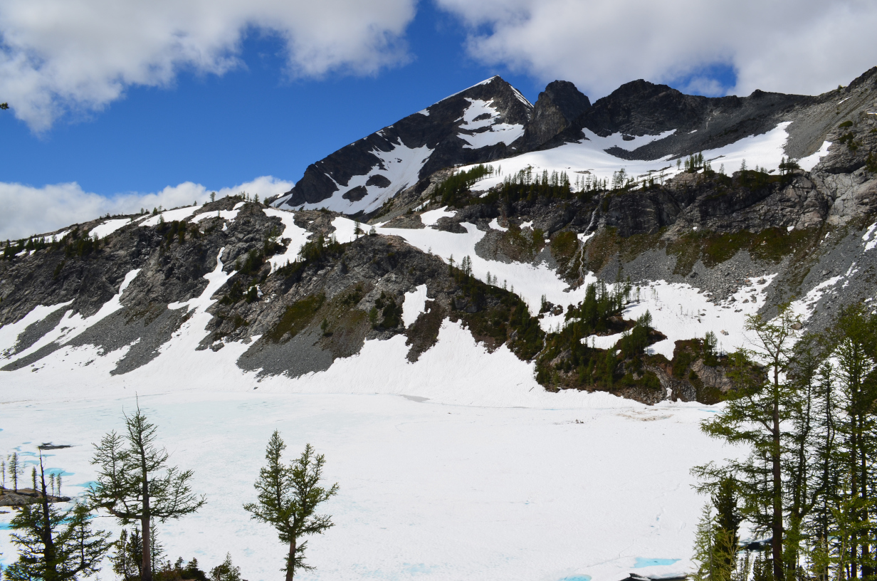 A view of Ice lake and the mountain above, with the lake full of snow and ice.