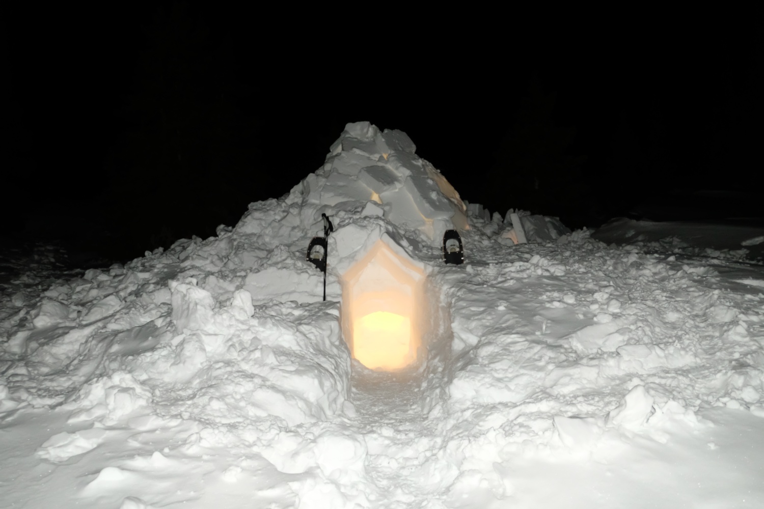 Looking at the igloo, with the lantern lighting the interior.