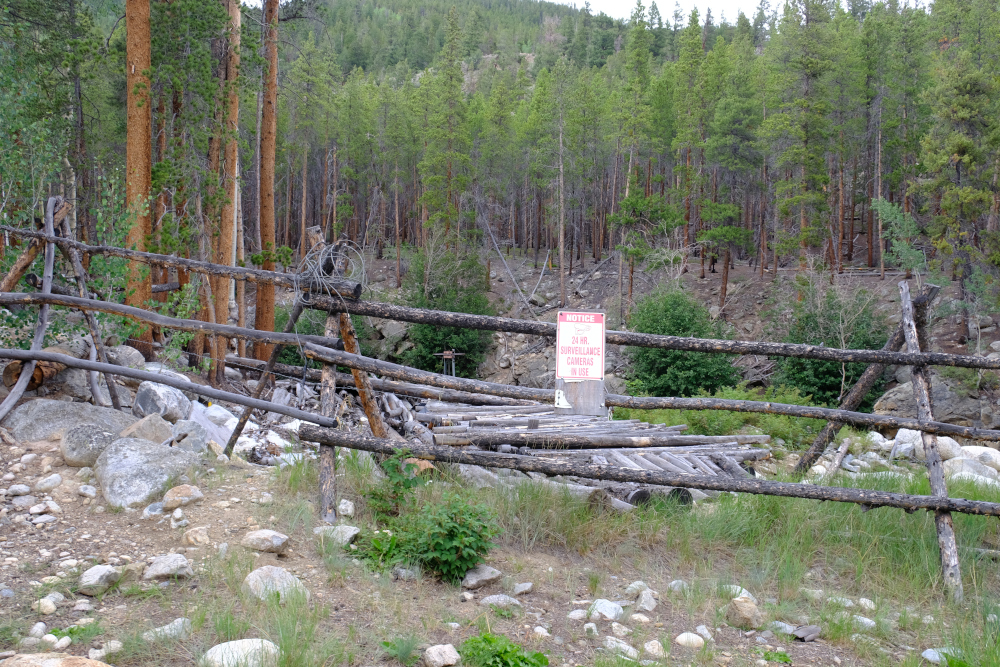 Sign on waterworks indicating surveillance.