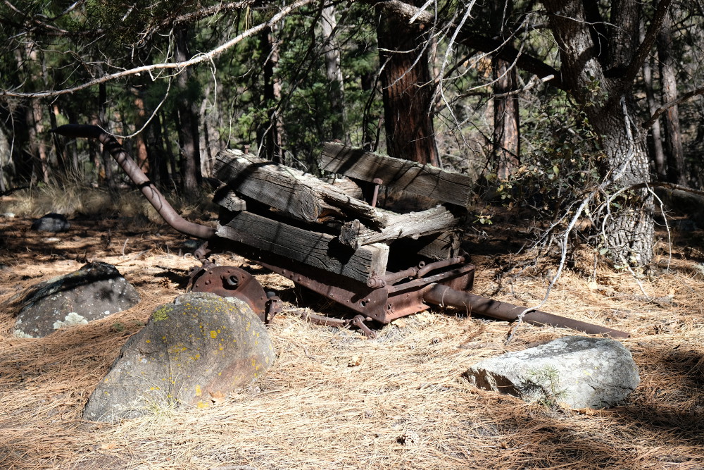 An old falling apart trailer, or maybe horse drawn cart.