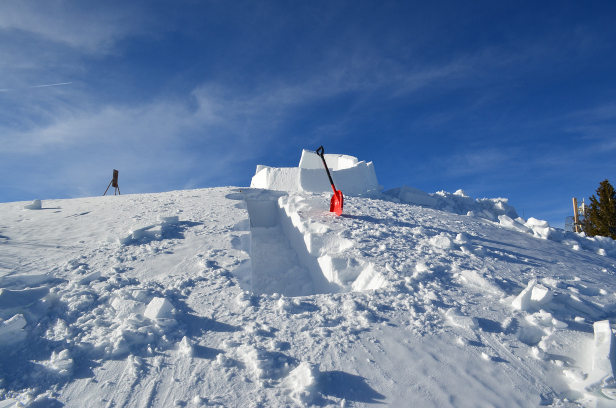 The snow block quarry with the partly-built igloo in the background.