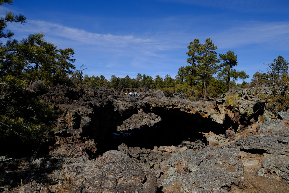 The group on a natural arch over the collapsed lava tube.