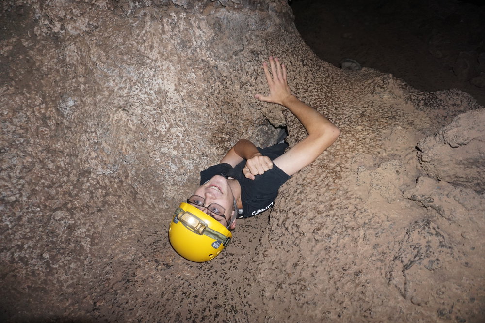 Tyler squeezing out of the tight crawl.