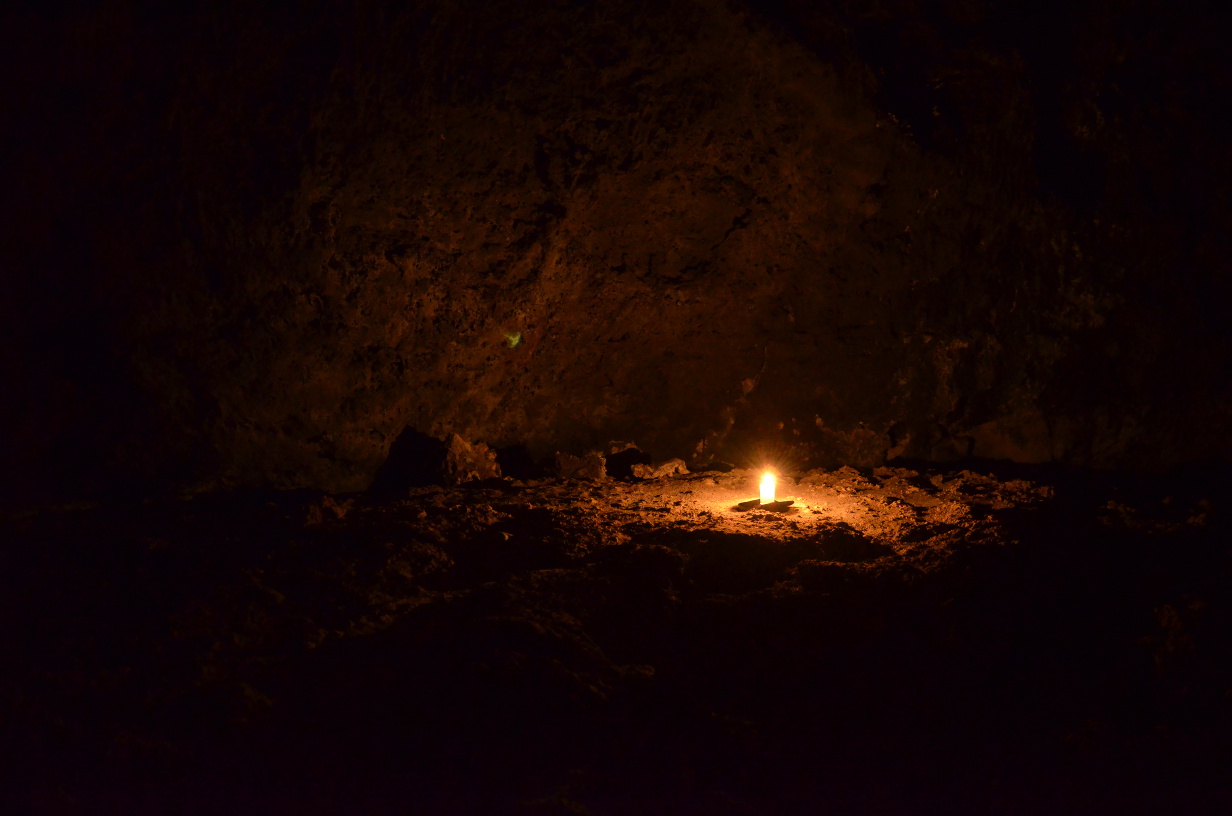 A lone candle inside the cave.