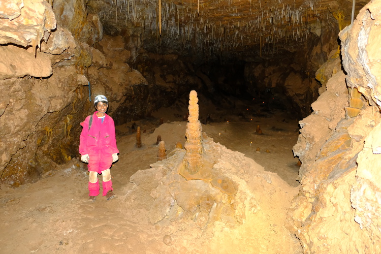 Eshani by a tall formation in platter room.