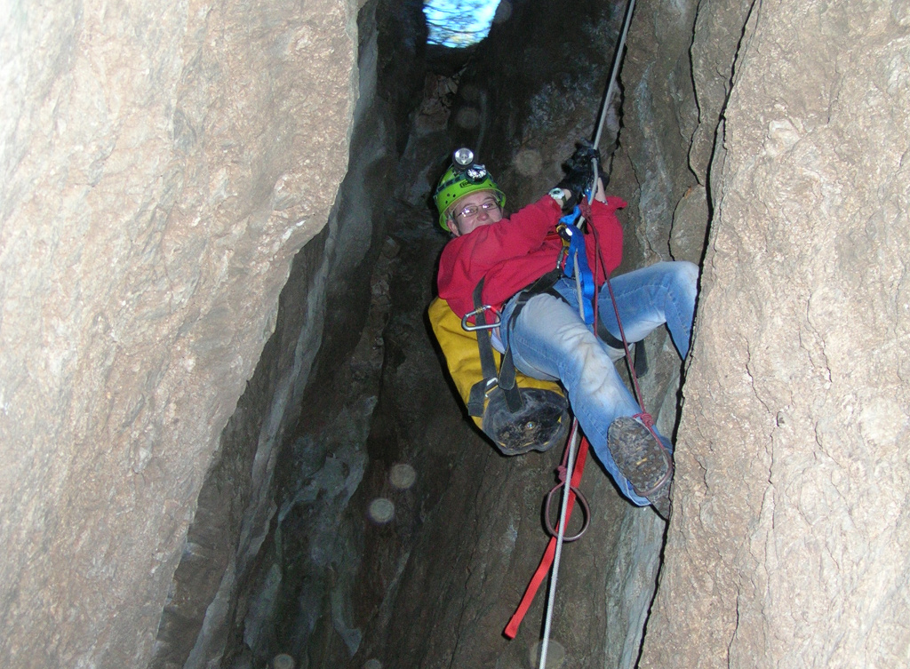 Candace ascending the rope out of Hidden Cave.