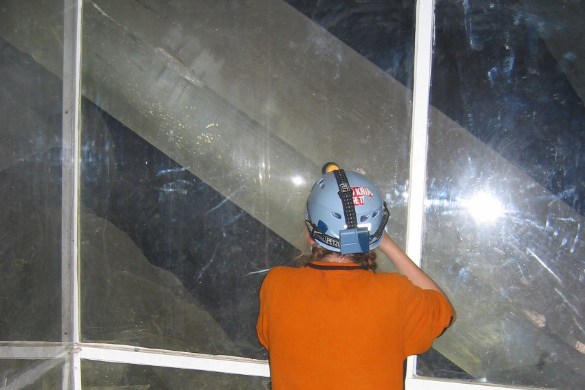 Christian standing in front of a large crystal.