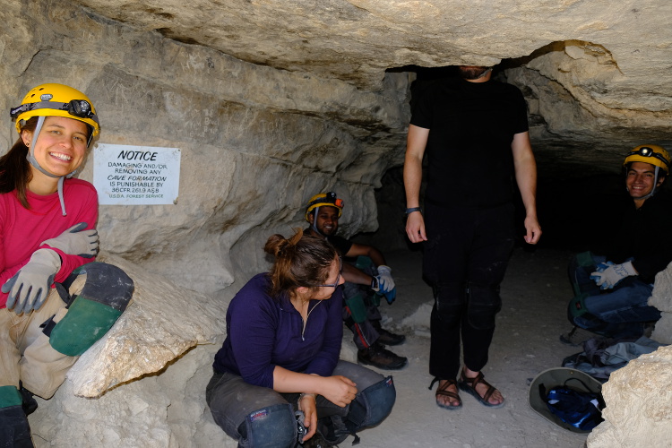 The trip leader, with his head in a hole in the cave ceiling.