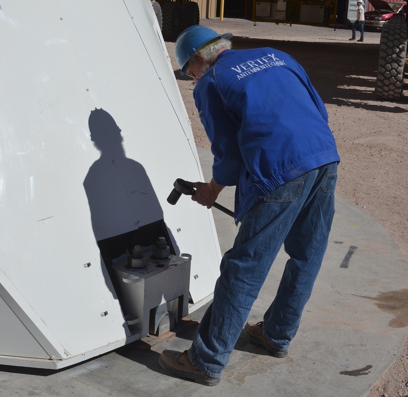 Unbolting an antenna.