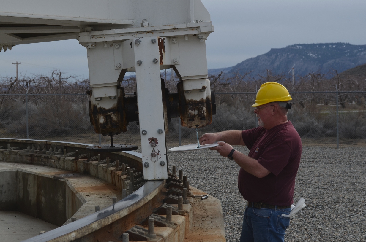 Station tech installing a drip tray