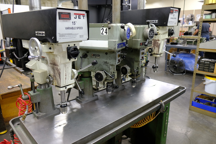 4 drill presses setup on one work bench.