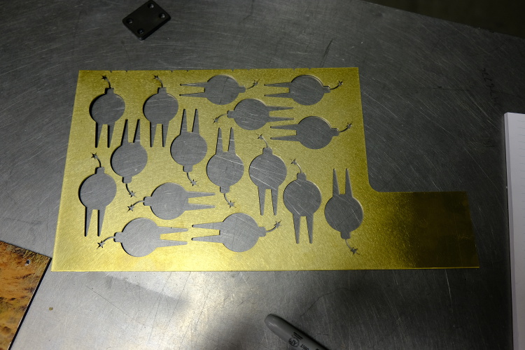 A sheet of metal with shapes cut out of it.
